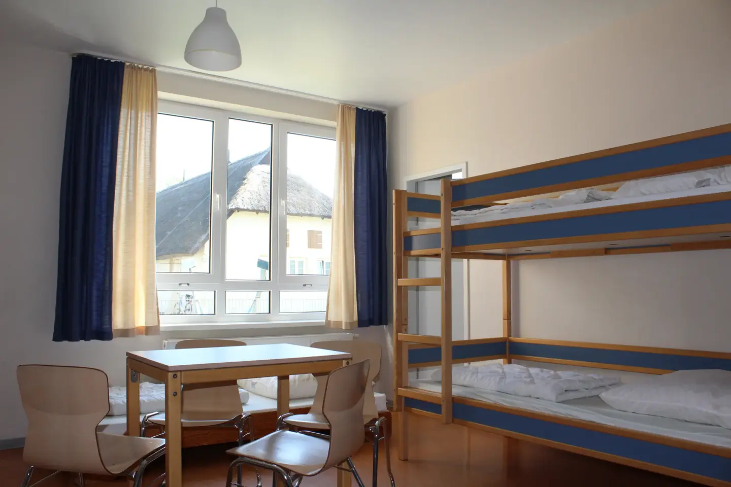Klassenfahrt Greifswald - Zimmer mit mehreren Betten und großem Fenster